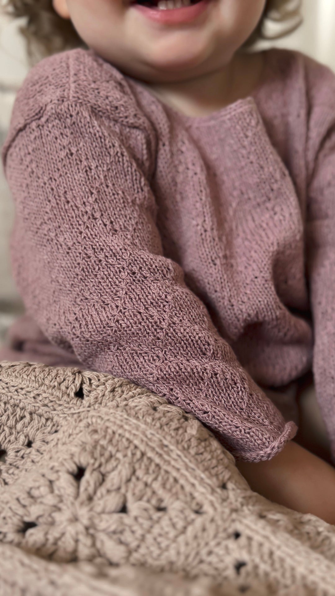 image shows baby wearing dusty pink organic silk diamond knit