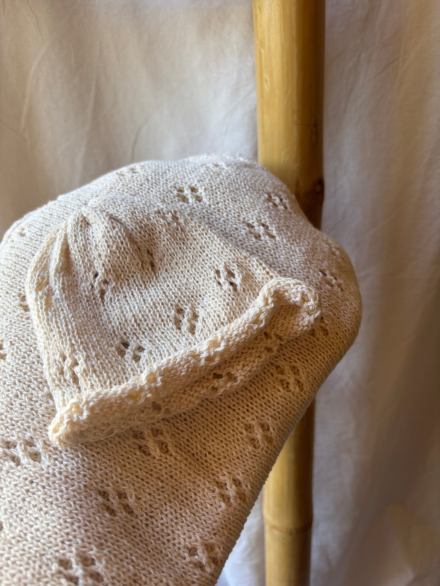 image shows neutral baby hat and swaddle