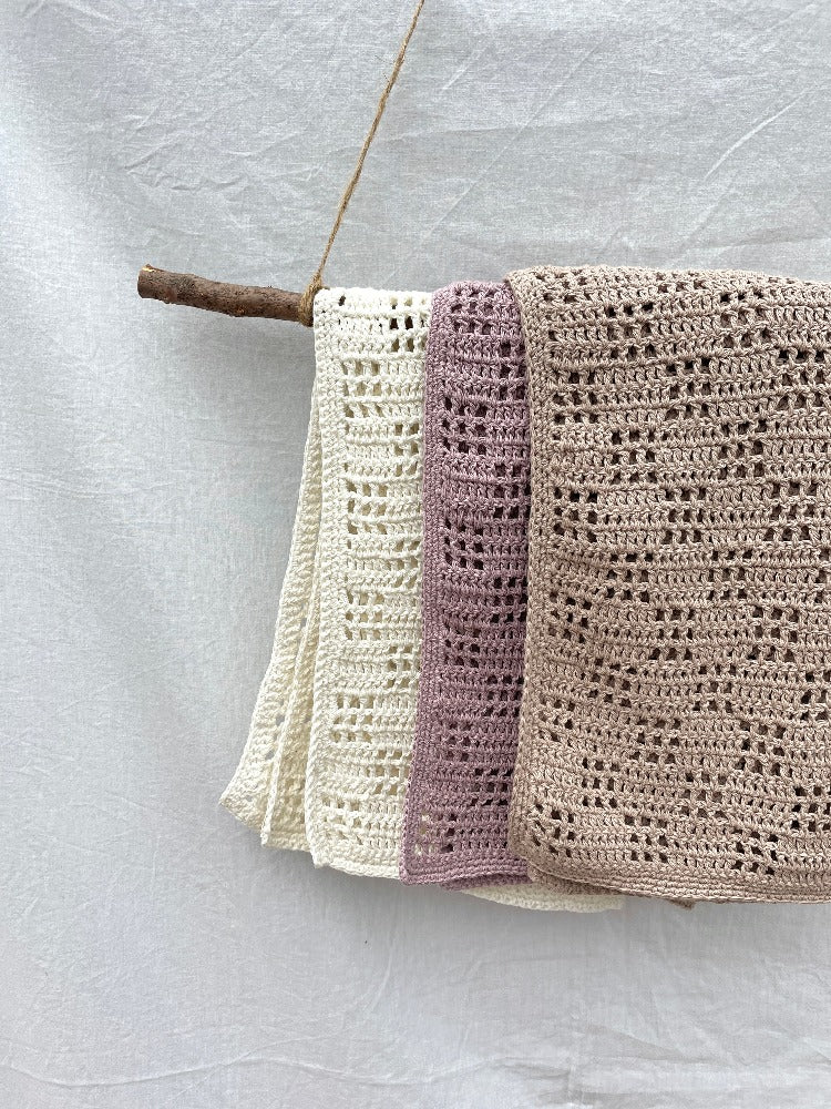 Organic cotton crochet baby blankets in neutral shades.